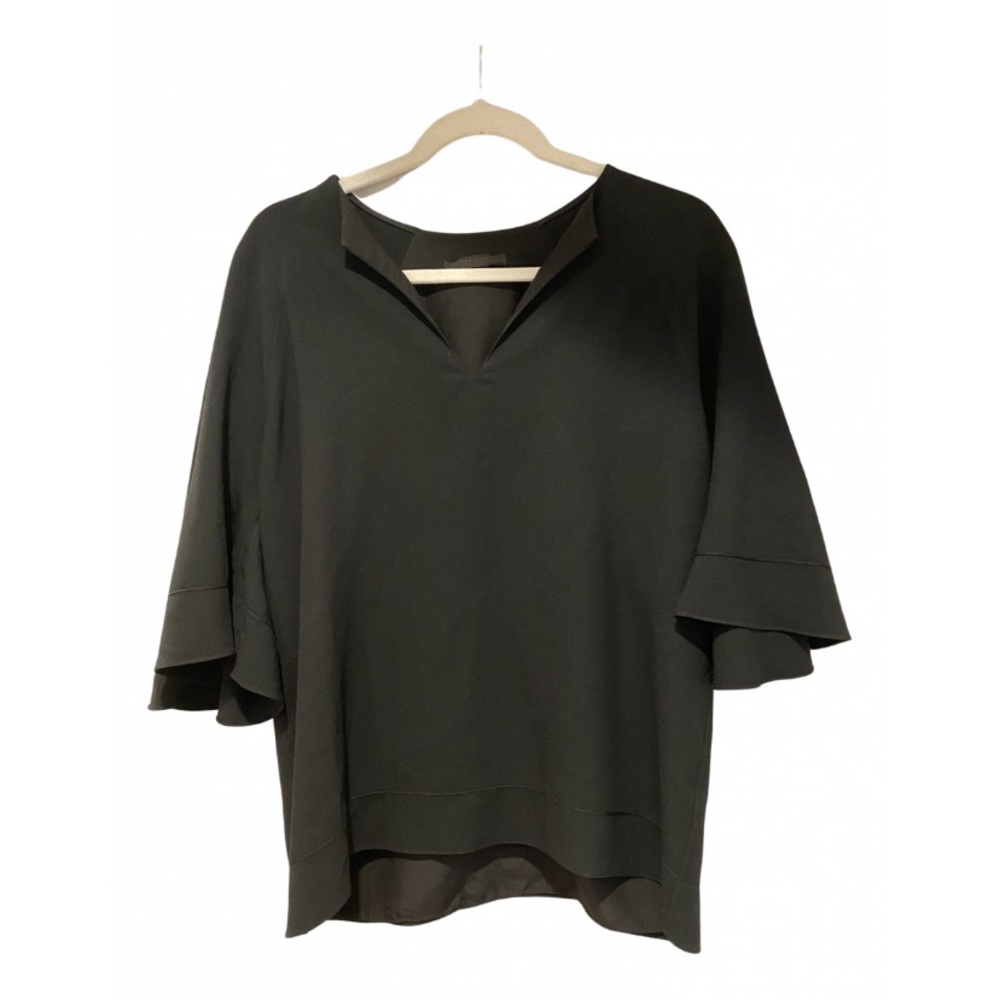 The Row black blouse. Flowy sleeves add a touch of elegance to this blouse.